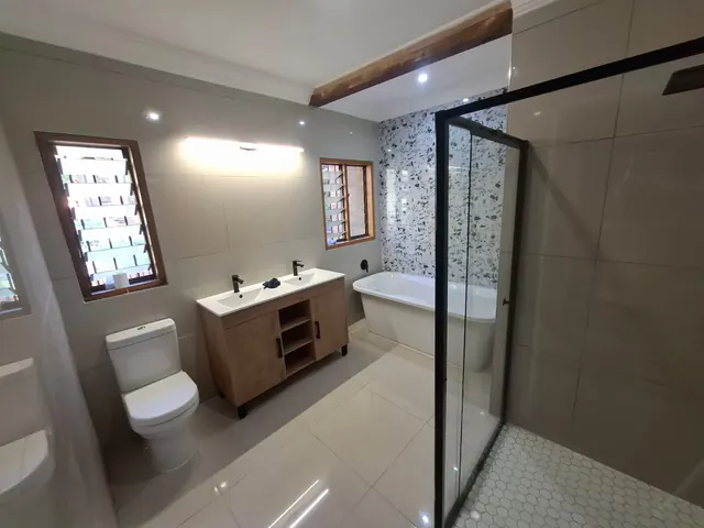 Finished Pretoria East bathroom with freestanding tub, terrazzo feature wall and double vanity