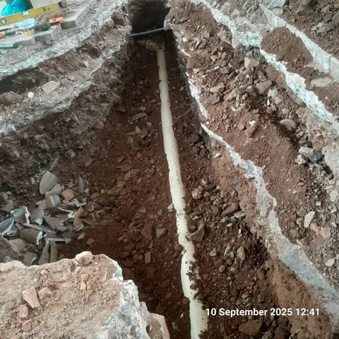 Underground pipe being laid in a trench during a plumbing installation in Pretoria East