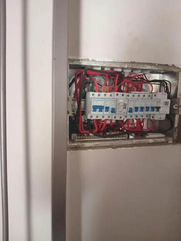 Recessed distribution board with live and neutral wiring and miniature circuit breakers